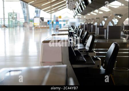 Row of empty check-in desks at an airport Stock Photo - Alamy