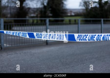 Police barrier tape at the scene of a crime in the UK. Stock Photo