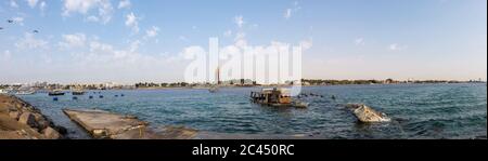 Sunken boat in the Red Sea, Jeddah, Saudi Arabia,Under construction tower Stock Photo