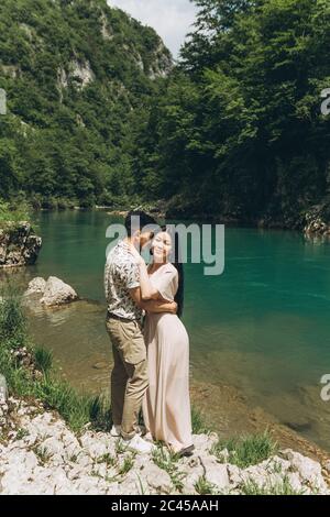 Young couple in the nature. A man hugs a woman. Stock Photo