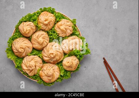 Veg Momos on gray concrete table top . Momos is the popular dish of indian, tibetan, chinese cuisines. Asian food. Vegetarian meal. Copy space. Top vi Stock Photo