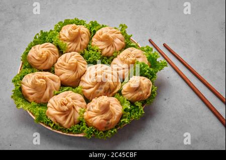 Veg Momos on gray concrete table top . Momos is the popular dish of indian, tibetan, chinese cuisines. Asian food. Vegetarian meal Stock Photo