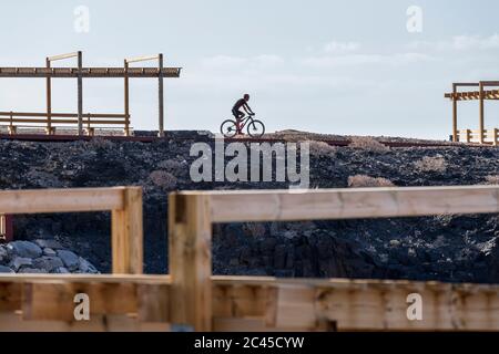 People walking and cycling on the new pedestrian walkway from Los Abrigos to Golf del Sur where it passes San Blas, Tenerife, Canary Islands, Spain Stock Photo