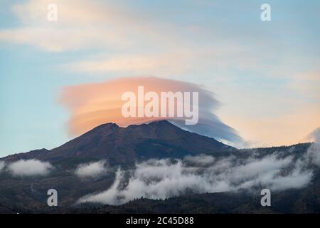 Lenticular cloud over the peak of Teide at sunset seen from Playa San Juan, Tenerife, Canary Islands, Spain Stock Photo