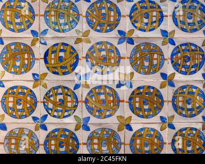 Fragment of building wall with ceramic wall tiles Azulejo close up.Traditional Portuguese architecture. Abstract decorative background, ornate pattern Stock Photo