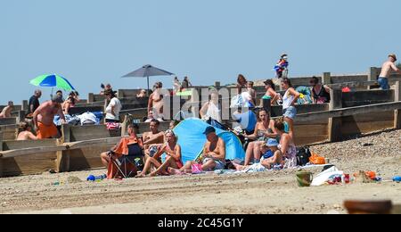 Worthing UK 24th June 2020 - Crowds on the beaches at Ferring near Worthing in West Sussex today as they enjoy the heatwave weather  with temperatures reaching 30 degrees in some parts of the South East   : Credit Simon Dack / Alamy Live News Stock Photo