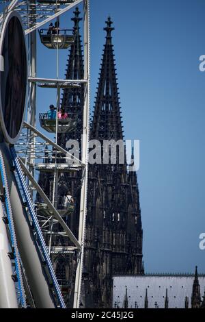 Cologne, Germany. 24th June, 2020. Tourists view the Cologne Cathedral from a Ferris wheel. Credit: Henning Kaiser/dpa/Alamy Live News Stock Photo