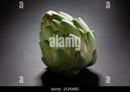 single artichoke on black background Stock Photo