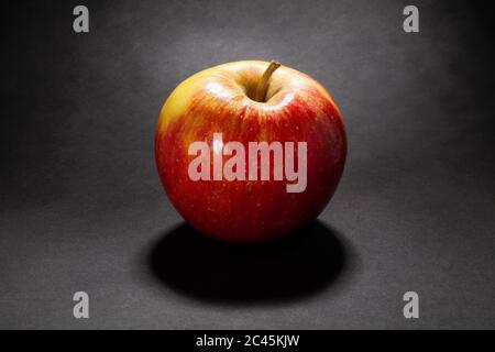 red yellow apple on black background Stock Photo
