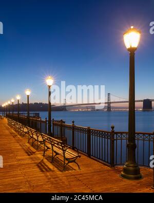 Evening view across the Bay, with Golden Gate Bridge in the distance, San Francisco, California, USA. Stock Photo