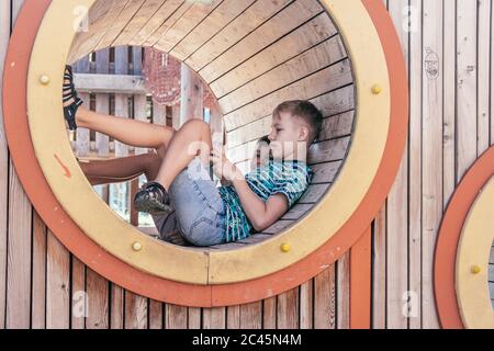 Handsome boy with smartphone playing game Stock Photo