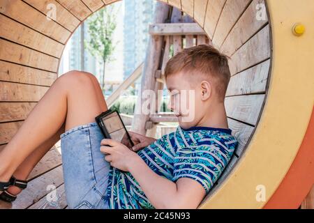 Handsome boy with smartphone playing game Stock Photo