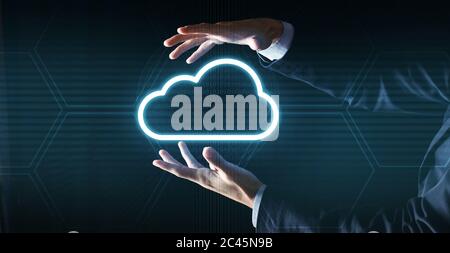 Cloud computing concept. Unrecognizable businessman in suit holding cloud icon projection Stock Photo