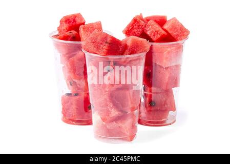 Close up sliced red watermelon cubes in plastic cup isolated on white. Stock Photo