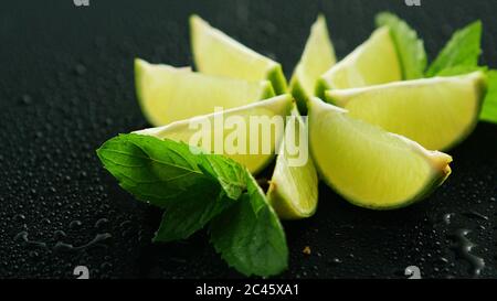 Lime segments with mint leaves Stock Photo
