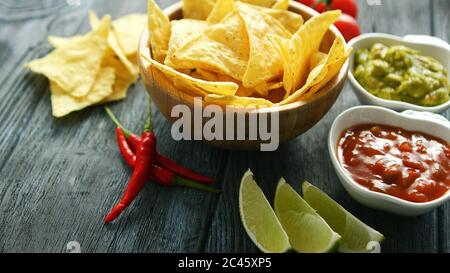Delicious nachos and sauces on table Stock Photo
