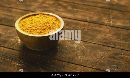 Small bowl of orange turmeric spice Stock Photo