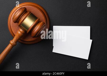 Judge wooden gavel with blank business cards on black Stock Photo