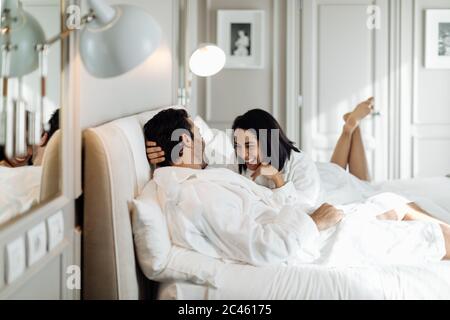 Couple laughing and relaxing in suite Stock Photo