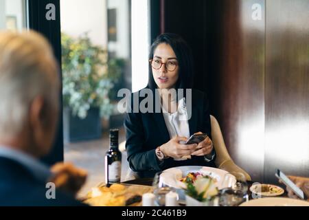Businesswoman and man having meeting in hotel restaurant Stock Photo