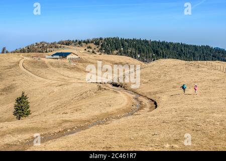 Two girls running on hiking trail on high plateau Stock Photo