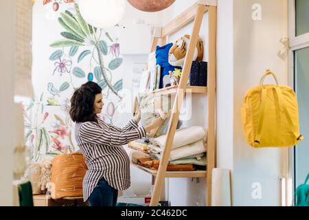 Pregnant woman shopping for new baby Stock Photo