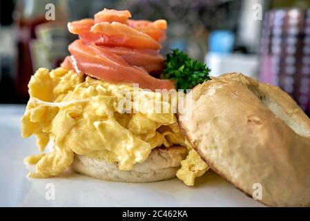 Smoked salmon and scrambled egg on a fresh bagel Stock Photo