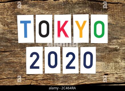 Tokyo 2020 words printed on paper on old wooden background close-up Stock Photo