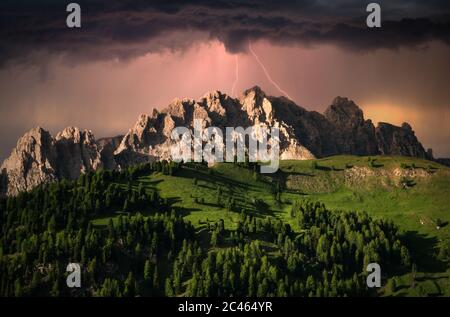 Dramatic clouds and lightning over mountain in Dolomite, Italy Stock Photo