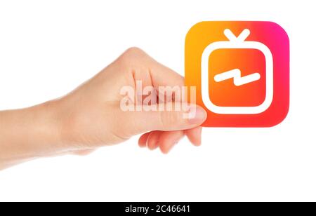 Kiev, Ukraine - February 21, 2019: Hand holds Instagram TV icon printed on paper. IGTV is a standalone vertical video Stock Photo