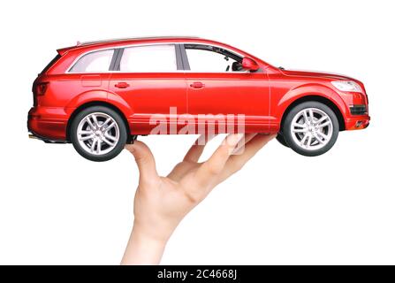 Kiev, Ukraine - May 15, 2019: Woman hand holding a big red car toy Audi on white background Stock Photo