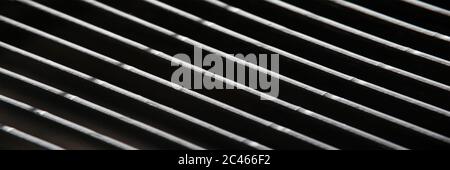 Dark gray metal grating in low light technique Stock Photo