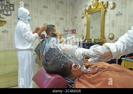 Dhaka, Bangladesh. 23rd June, 2020. Hairdressers in protective suits work at a salon during the COVID-19 pandemic in Dhaka, Bangladesh, June 23, 2020. Credit: Str/Xinhua/Alamy Live News Stock Photo