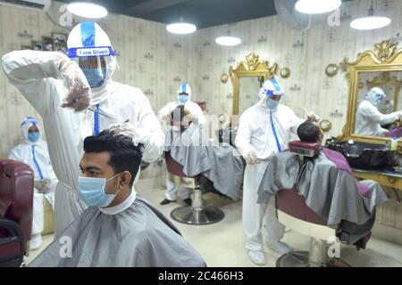 Dhaka, Bangladesh. 23rd June, 2020. Hairdressers in protective suits work at a salon during the COVID-19 pandemic in Dhaka, Bangladesh, June 23, 2020. Credit: Str/Xinhua/Alamy Live News Stock Photo