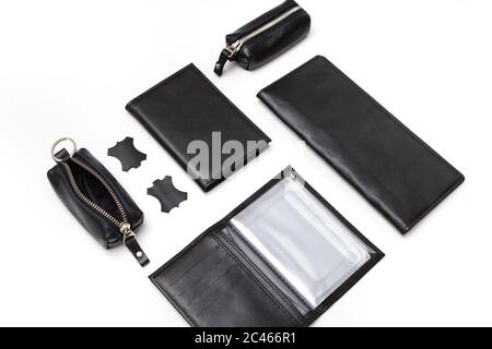 Fashionable black leather male accessories isolated on white background. Male accessories. Wallet, purse, key holder, business card holder. Top view Stock Photo