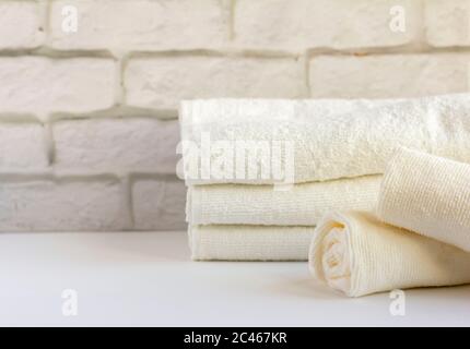 A stack of clean white Terry towels on a light background Stock Photo