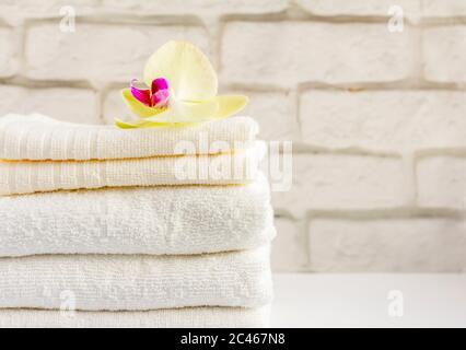 A stack of clean white Terry towels on a light background Stock Photo