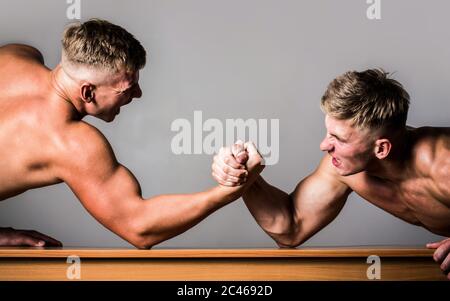 Men measuring forces, arms. Hand wrestling, compete. Hands or arms of man. Muscular hand. Arm wrestling. Two men arm wrestling. Rivalry, closeup of Stock Photo