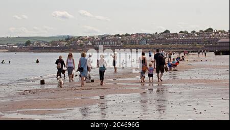 Portobello, Edinburgh, Scotland, UK. 24 June 2020. The hot weather brought families out but the seaside was not overly busy, plenty room to keep a social distance on the beach and promenade. People out on various paddle boards and inflatables and others having picnics on the sandy beach. Stock Photo