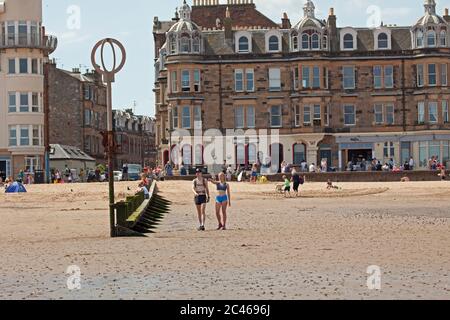 Portobello, Edinburgh, Scotland, UK. 24 June 2020. The hot weather brought families out but the seaside was not overly busy, plenty room to keep a social distance on the beach and promenade. People out on various paddle boards and inflatables and others having picnics on the sandy beach. Stock Photo