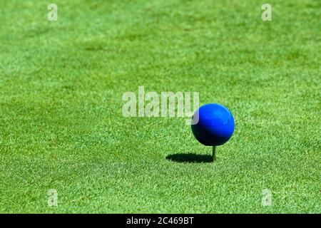 A Close up View of a Blue Tee Marker on a Golf Course on a Sunny Day. n. Stock Photo