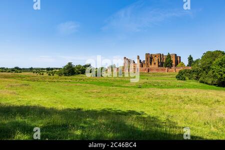 The ruins of Kenilworth Castle across the Great Mere, Warwickshire, England Stock Photo