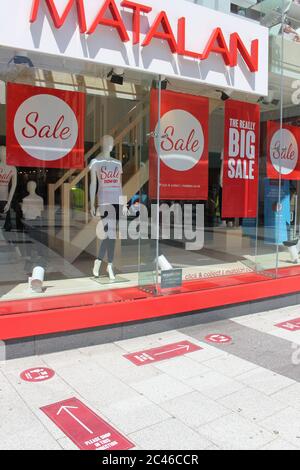 A photograph of social distancing measures and large sale signs at Cardiff Queen Street's Matalan store. Stock Photo