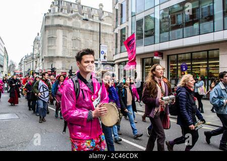 LONDON/ENGLAND – FEBRUARY 22 2020: Extinction Rebellion protesters playing the drums during the February 2020 March along with Parents 4 Future Stock Photo