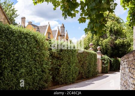 A glimpse of 16th century (1590) Ablington Manor in the Cotswold village of Ablington, Gloucestershire UK Stock Photo