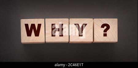 Why Closeup of word with question mark on wooden cubes on dark grey desk background. Reason why business or relationship concept Stock Photo