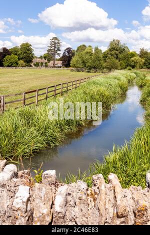 The River Coln passing the Cotswold village of Coln Rogers in the Coln Valley, Gloucestershire UK Stock Photo