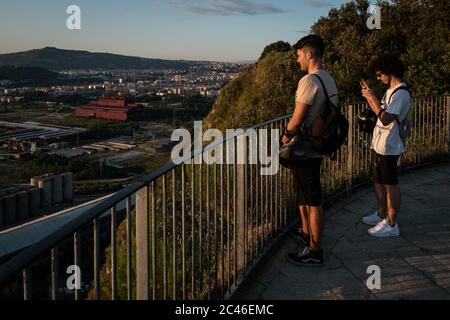 Naples, Italy. 23rd June, 2020. NAPLES, ITALY - JUNE 23 - Young boys watch the sunset from the viewpoint of the Virgilian Park of Posillipo in Naples, June 23, 2020. Credit: Manuel Dorati/ZUMA Wire/Alamy Live News Stock Photo