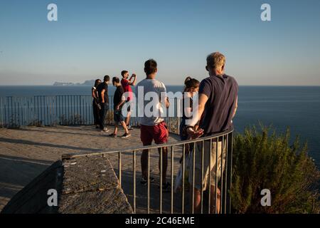 Naples, Italy. 23rd June, 2020. NAPLES, ITALY - JUNE 23 - Young boys watch the sunset from the viewpoint of the Virgilian Park of Posillipo in Naples, June 23, 2020. Credit: Manuel Dorati/ZUMA Wire/Alamy Live News Stock Photo