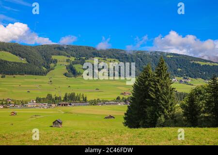 Beautiful green alpine fields. Small villages high in the mountains Stock Photo